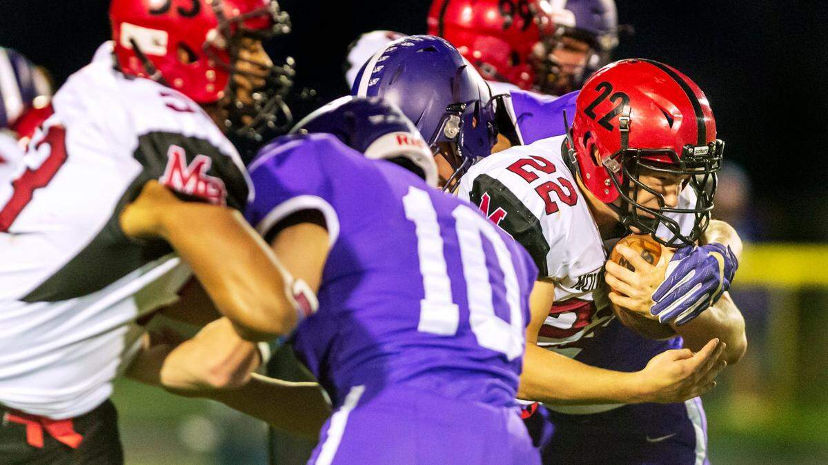 Mount Baker running back Jesse Sande (22), right, breaks the line of scrimmage to make a first down during the first quarter on Oct. 8 at Nooksack Valley High School in Everson.