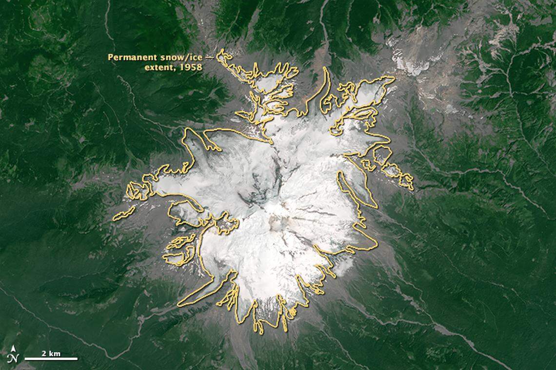 A photograph of Mount Baker taken by NASA’s Landsat 8 satellite shows the 10,781-foot volcano east of Bellingham during the “snow drought” in July 2015. A graphic overlay shows how the mountain’s glaciers have retreated.