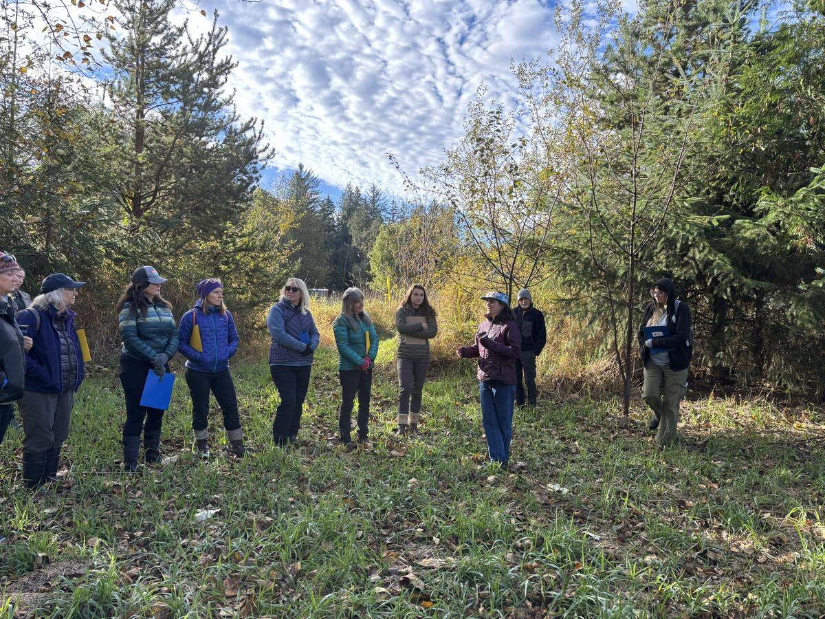 Jennifer Dowd talks to donors and volunteers of the Whatcom Land Trust while on a tour of the new outdoor field campus for students of Exploration Academy.