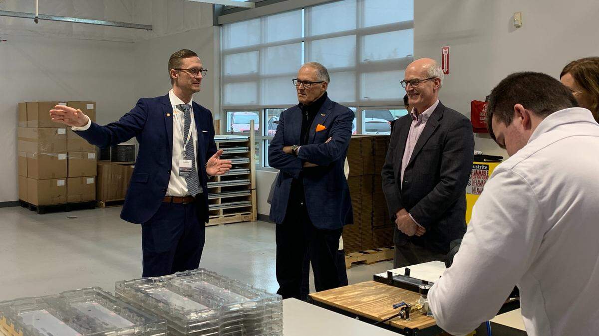 Washington Gov. Jay Inslee and U.S. Rep. Rick Larsen, D-2nd District, listen to a Corvus Energy representative on a tour of the facility Monday, Jan. 23, in Bellingham. This is the first Corvus Energy facility in the United States and is located in Fairhaven.