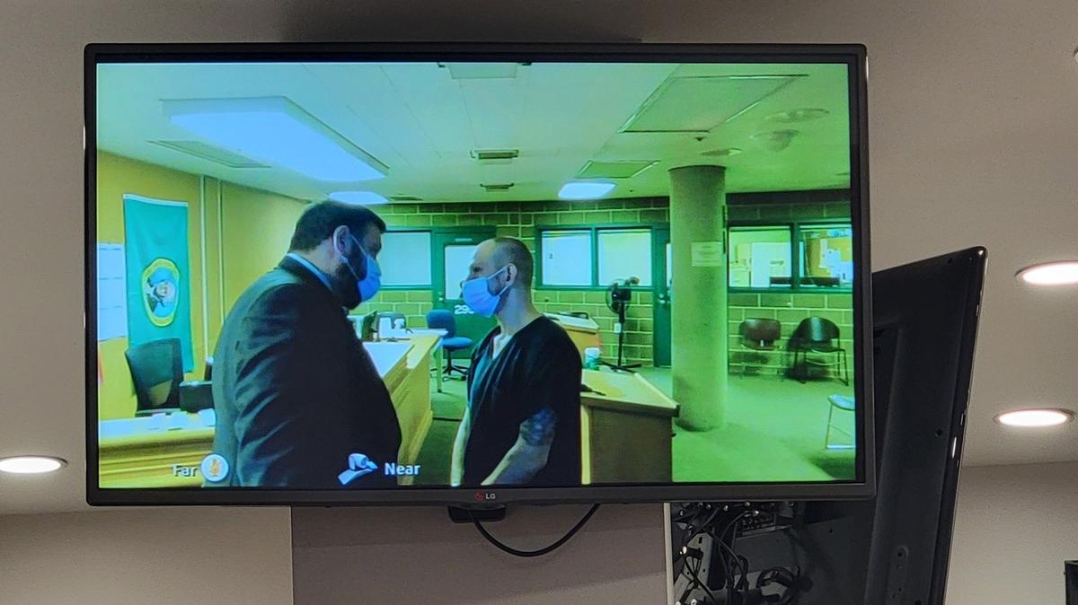 Public defense attorney Peter Ramey talks with Shilo Aaron Englert, 33, of Bellingham during a video appearance Tuesday, Feb. 22, in Whatcom County Superior Court. Englert’s bail was set at $1 million as he is charged with one count of second-degree murder for the Feb. 8 death of 31-year-old Kasaundra Booker.
