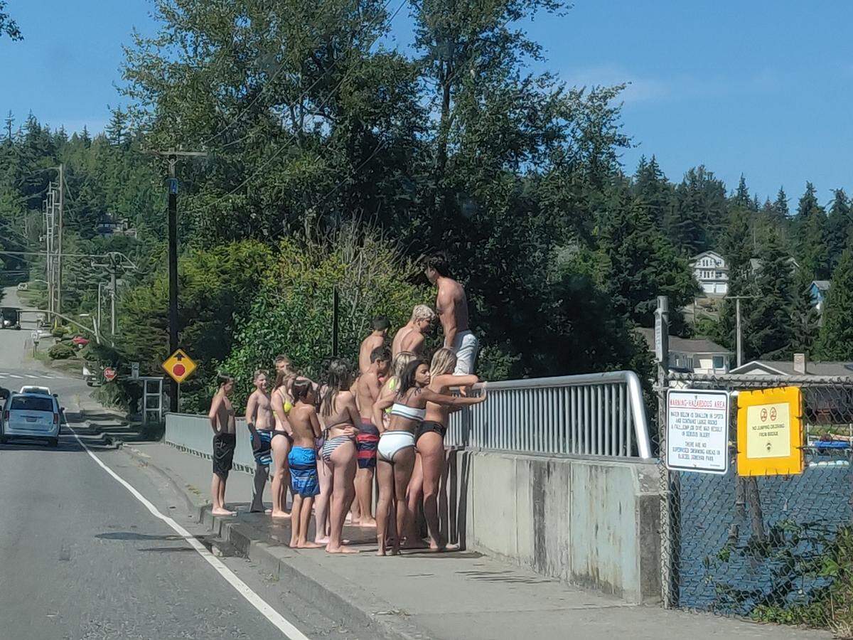 Young swimmers gather on the Electric Street bridge, where some jump into Lake Whatcom Monday, July 27, near Bloedel Dononvan Park in Bellingham.