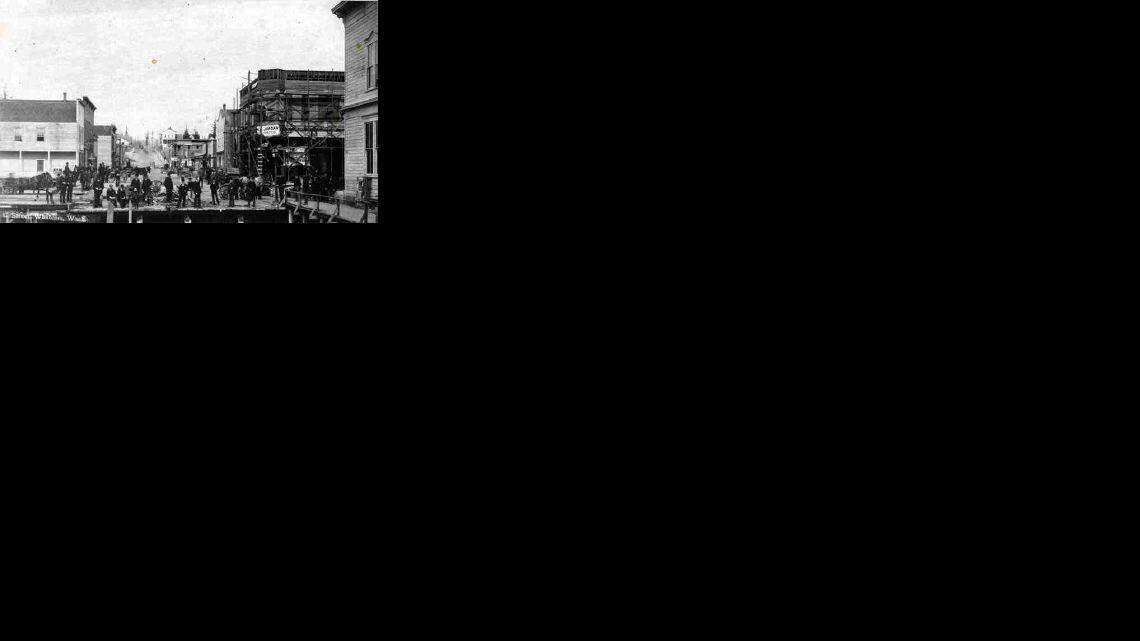 This rare view of C Street shows the roadway connecting Holly Street with Dupont Street. Holly, which runs across the picture, was a bridge at the time. Landfill later drastically altered the Bellingham Bay shoreline. In the distance stands the three-story Reveille newspaper building at C and Dupont.