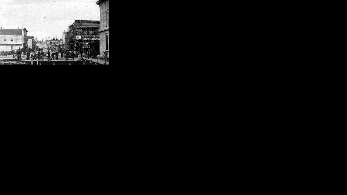 This rare view of C Street shows the roadway connecting Holly Street with Dupont Street. Holly, which runs across the picture, was a bridge at the time. Landfill later drastically altered the Bellingham Bay shoreline. In the distance stands the three-story Reveille newspaper building at C and Dupont.