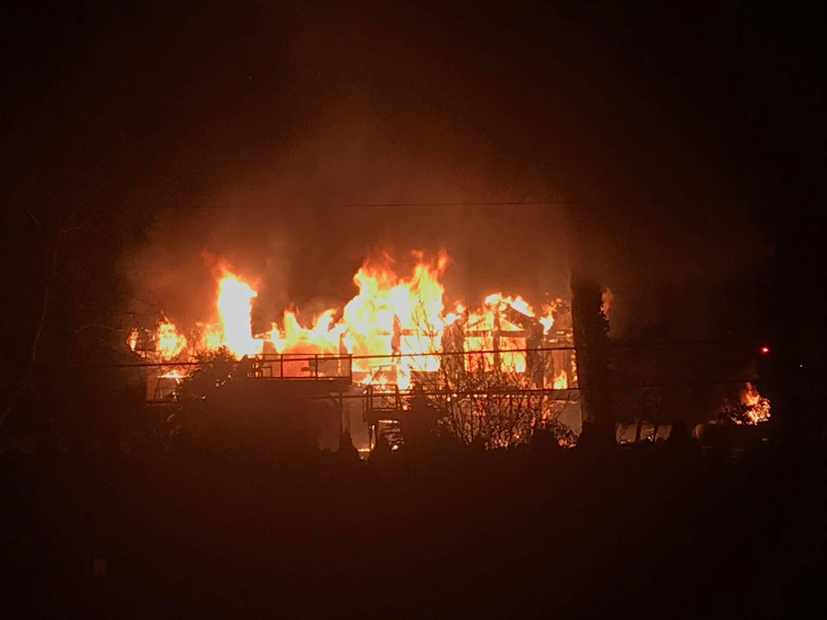 A two-alarm structure fire burns early Wednesday along the 900 block of Chuckanut Drive south of Bellingham.
