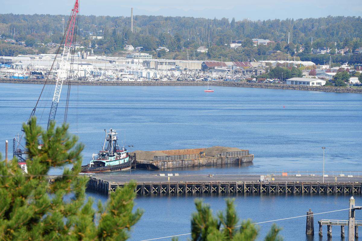A barge in the Whatcom Waterway assisted with the Shipping Terminal Modernization and cleanup project on September 23, 2025, in Bellingham, Wash. The gravel on the barges was being placed on the sea floor after dredging to form a new, clean top layer.