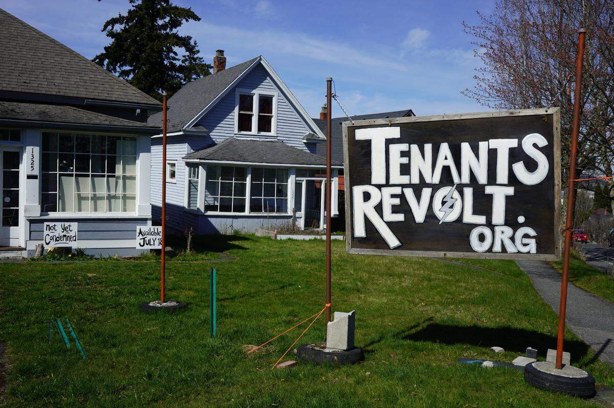 A Tenants Revolt sign is posted outside the home at 1325v Billy Frank Jr. St.
