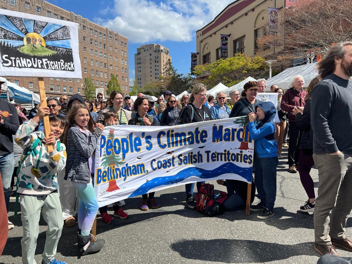 Those in attendance participate in a “Protect Mother Earth!” cheer at an Earth Day rally and festival sponsored by Children of the Setting Sun on Bay Street in downtown Bellingham on Tuesday, April 22, 2025.
