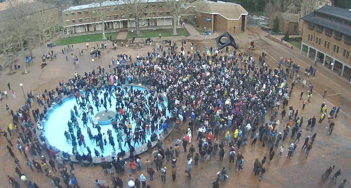 In this screenshot from a campus camera feed, students gather Friday after walking out of class at Western Washington University to protest the Trump administration’s immigration enforcement tactics and recent ICE-related killings.