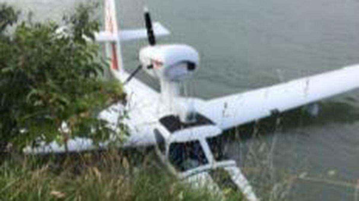 A single engine aircraft rests on the south shore of the Skagit River about 600 yards west of the I-5 Bridge Saturday evening, June 27, in Mount Vernon.