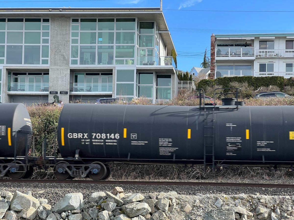 A BNSF freight train carrying oil tankers rolls past apartments along the waterfront in Boulevard Park on March 1. The area is part of the new Fairhaven railroad quiet zone where engineers don’t have to blow their horns at every crossing.