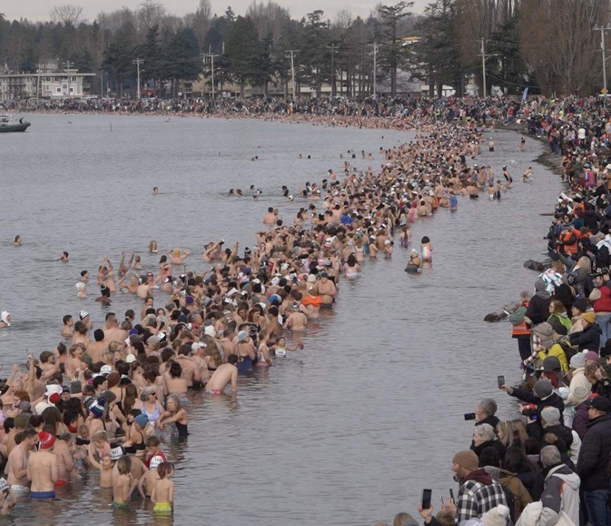 Thousands waded into the bay to attempt to break the world record for the largest polar bear dip on January 1, 2026, in Birch Bay, Wash.