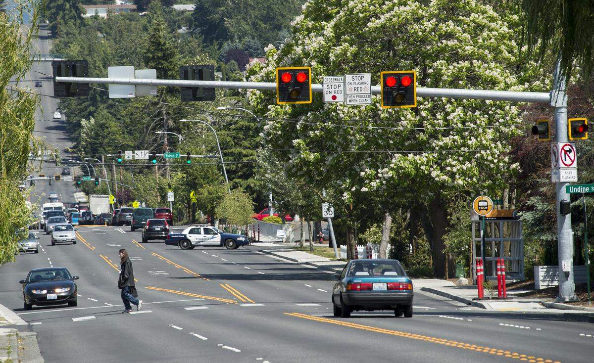 Cars stop for a pedestrian crossing Alabama Street. A 2015 project on the Alabama Street corridor added pedestrian crossings and bike lanes and connected parts of Sunnyland and Roosevelt neighborhoods that had been separated for years by the busy street