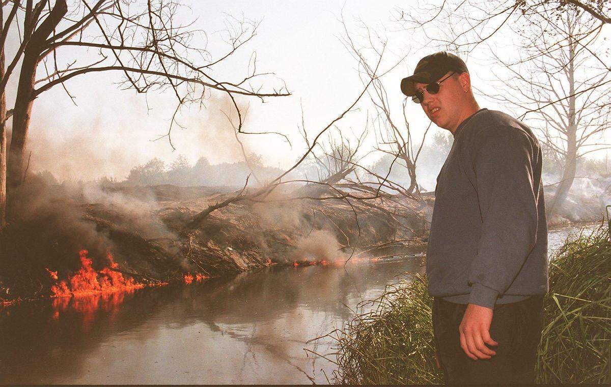 Bellingham resident Kelly Miller looks at the devastated Whatcom Creek, after a gasoline pipeline exploded, sending a fireball down the creek on June 10, 1999.