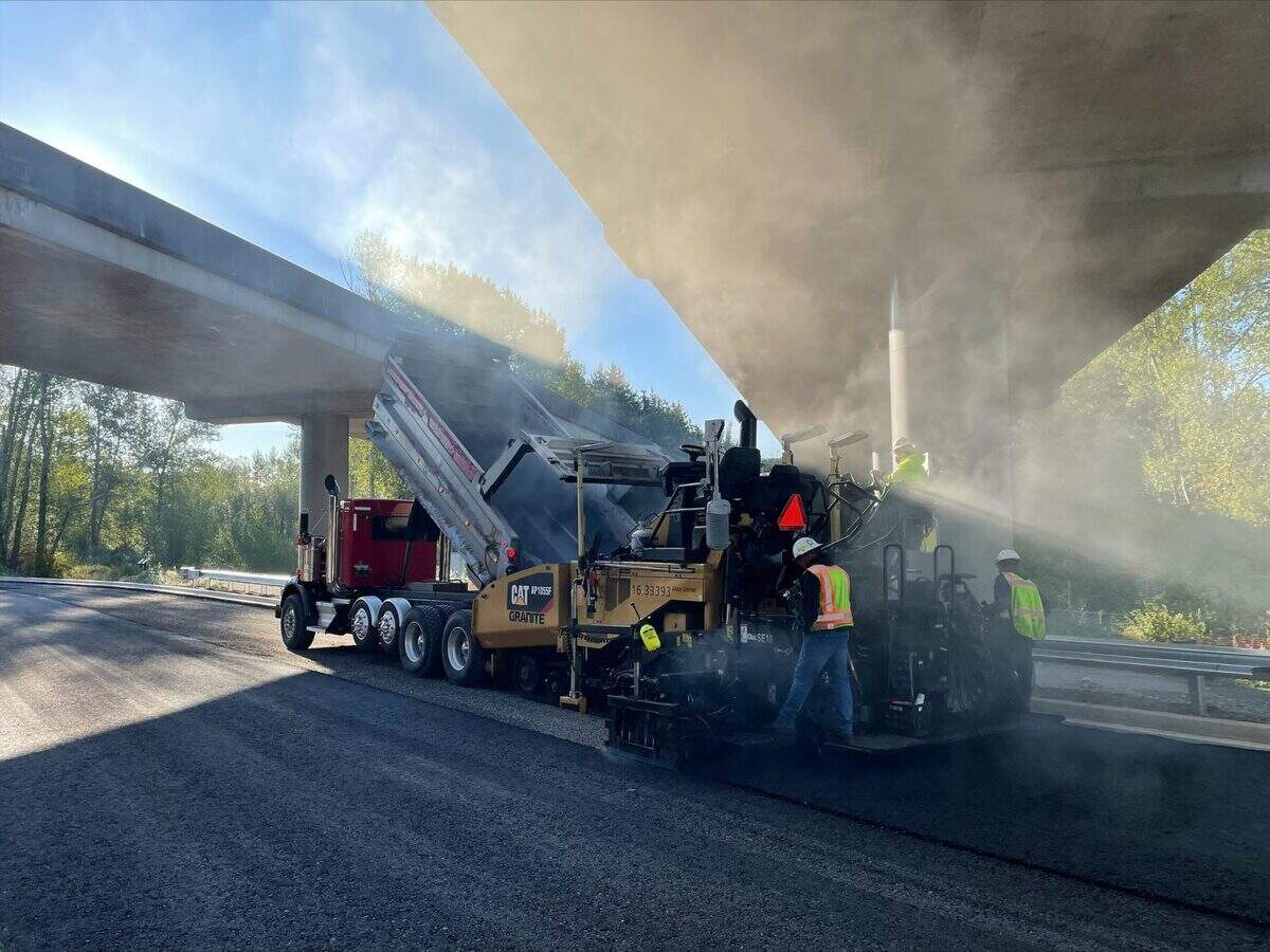 Crews work to pave the Orchard Drive connector underneath Interstate 5 in Bellingham last summer. The road will be known as Birchwood Avenue, and it is now scheduled to open before the end of the month.