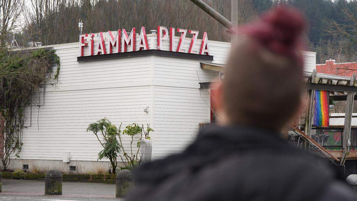 Rachel Weedman, a former employee of Fiamma Pizza, stands in front of the business on Feb. 18. Weedman said she intends to take legal action against the company after the Department of Labor determined it owes more than $82,000 in back wages to 73 employees due to violations involving tip pool collection and overtime payments.