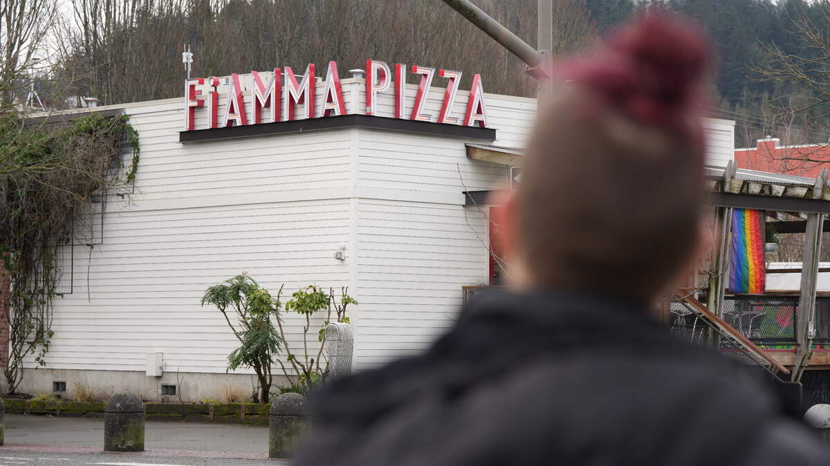 Rachel Weedman, a former employee of Fiamma Pizza, stands in front of the business on Feb. 18. Weedman said she intends to take legal action against the company after the Department of Labor determined it owes more than $82,000 in back wages to 73 employees due to violations involving tip pool collection and overtime payments.
