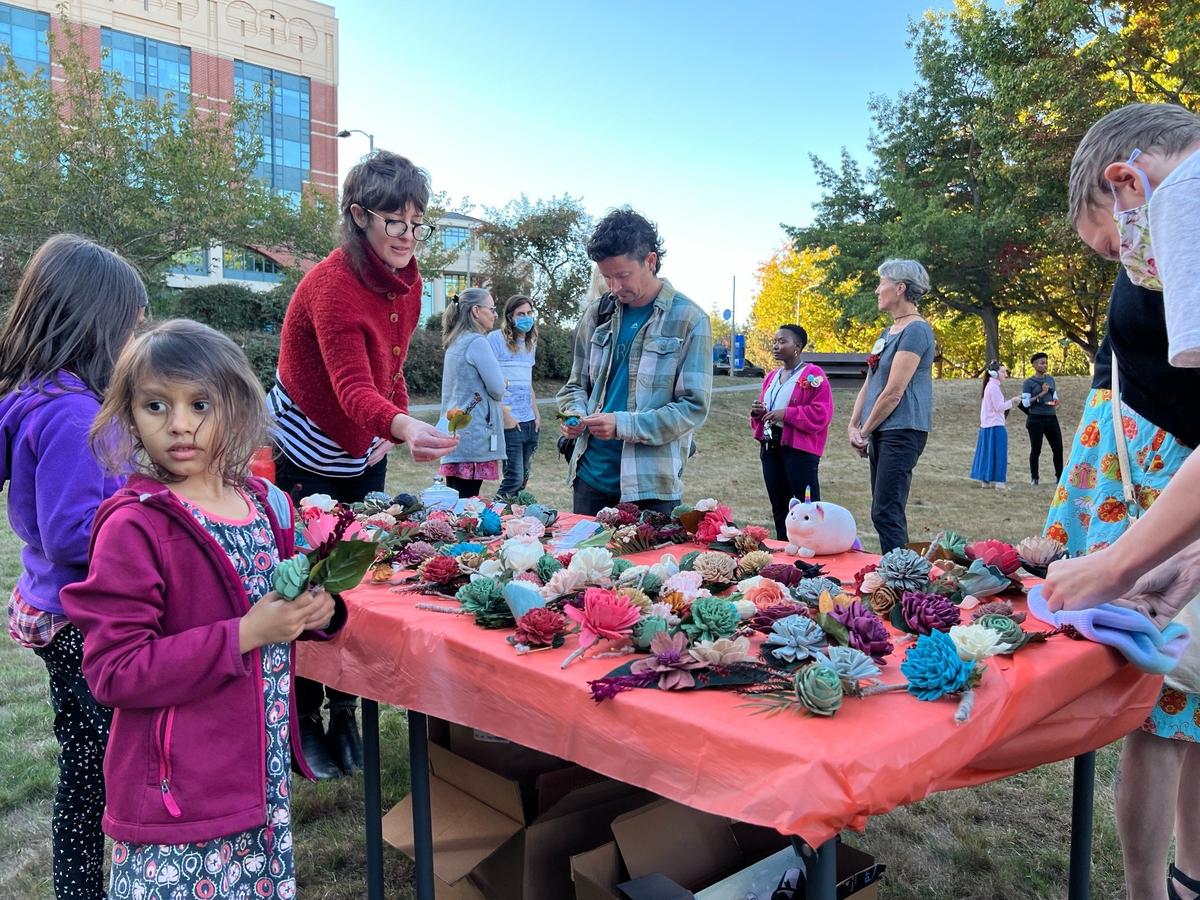 Participants wore boutonnieres signifying their support for forming a countywide Whatcom County Racial Equity Commission at a rally outside the Bellingham Public Library in Bellingham before the County Council voted to create the commission Tuesday, Oct. 11.