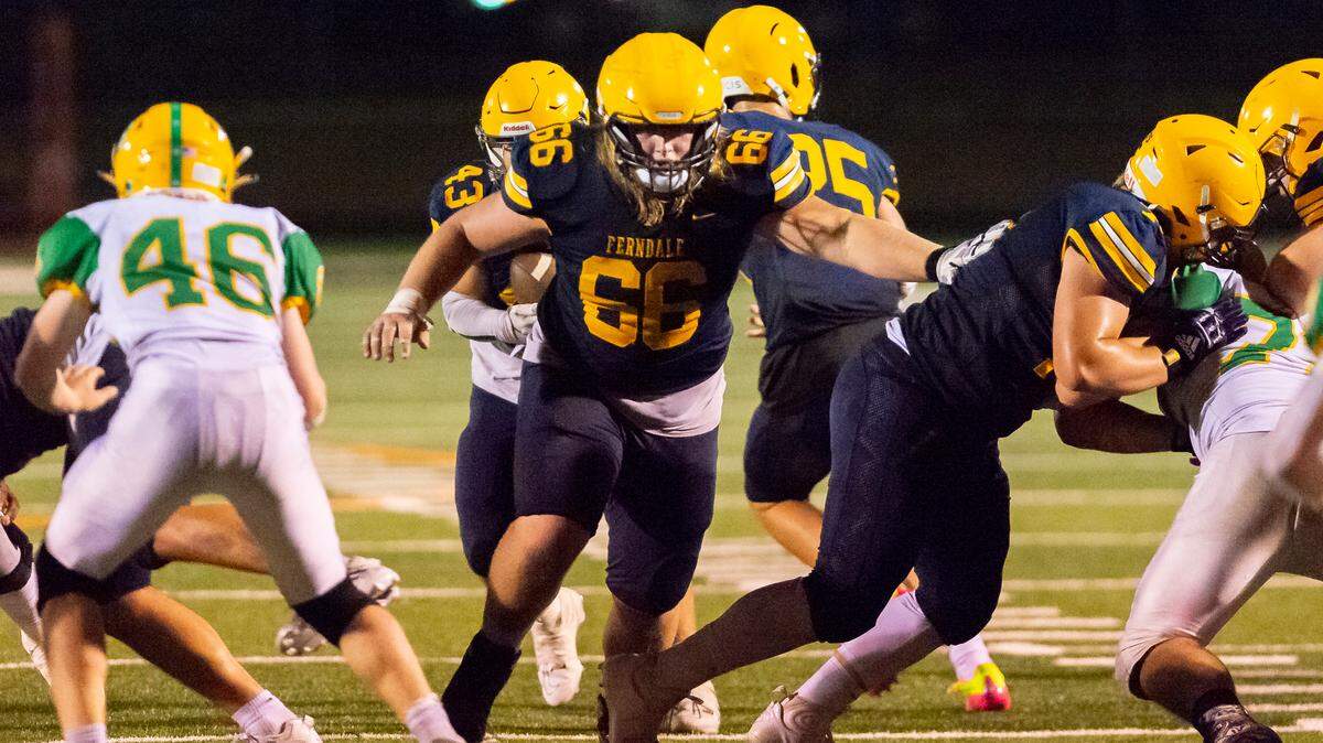 Ferndale offensive lineman Landen Hatchett (66) clears a path for running back Jason Nowak (43) during the third quarter on Friday evening Sept. 2, at Blaine High School. Lynden defeated Ferndale 24 to 7 in their season opener.