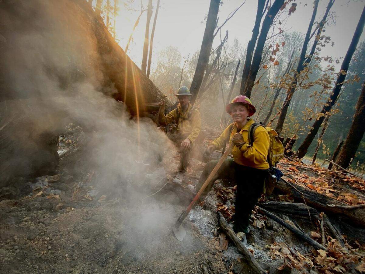 Crews mop up at an area of the Bolt Creek fire, one of several wildfires that continue to burn in the region and contribute much of the smoke in the area. The fire will continue to produce smoke as it burns to the north into Wild Sky Wilderness in the Mount Baker-Snoqualmie National Forest, according to an update Tuesday, Oct. 11, 2022.
