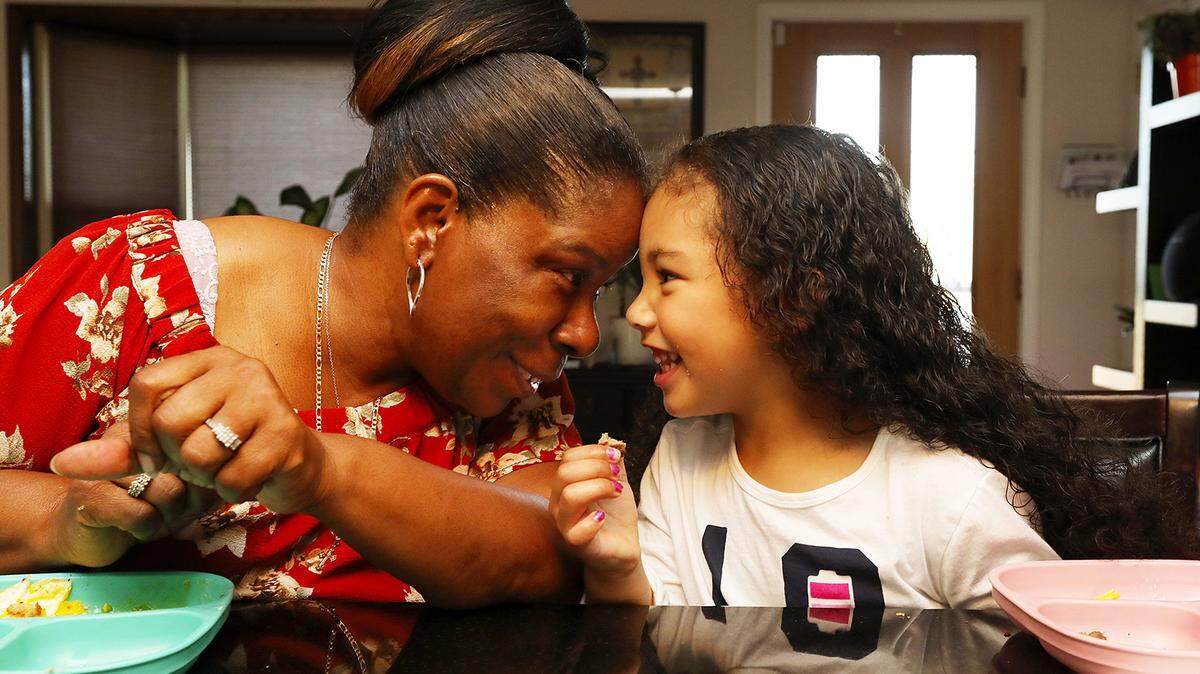 Alesia Cannady has breakfast with her 4-year-old granddaughter Aleiyah Cannady before taking her to preschool in September 2018 in Seattle. Alesia, 64, has a standard reply to those who ask what she’ll do in her situation, raising a child later in life: “Whatever I’m going to do, I’m going to do it with her.”