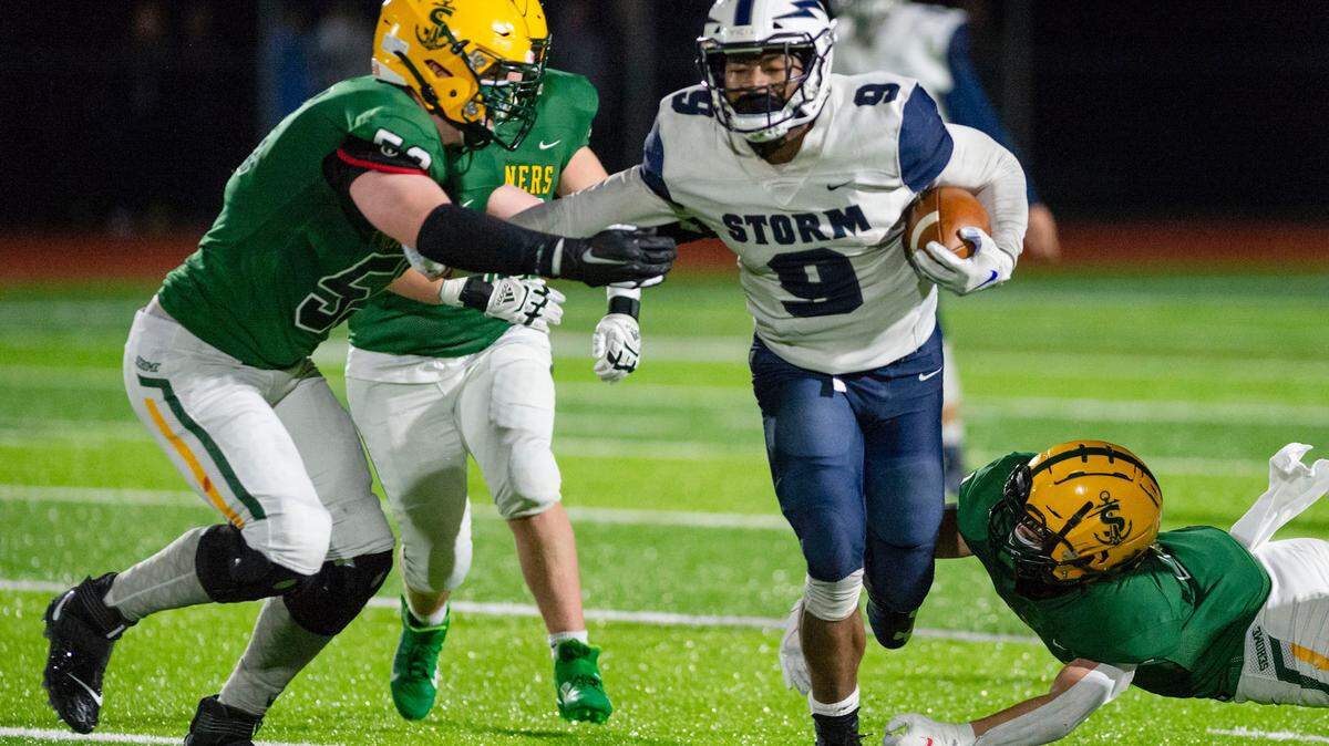 Squalicum running back Djouvensky Schlenbaker (9) breaks the line of scrimmage before being stopped after a short gain by Sehome defenders Gavin Ortega (53), left, and Elijah Ashmann (1) on Friday evening March 12, 2021, at Sehome High School in Bellingham, Wash. Squalicum defeated Sehome 54 to 20. (Paul Conrad for the Bellingham Herald)