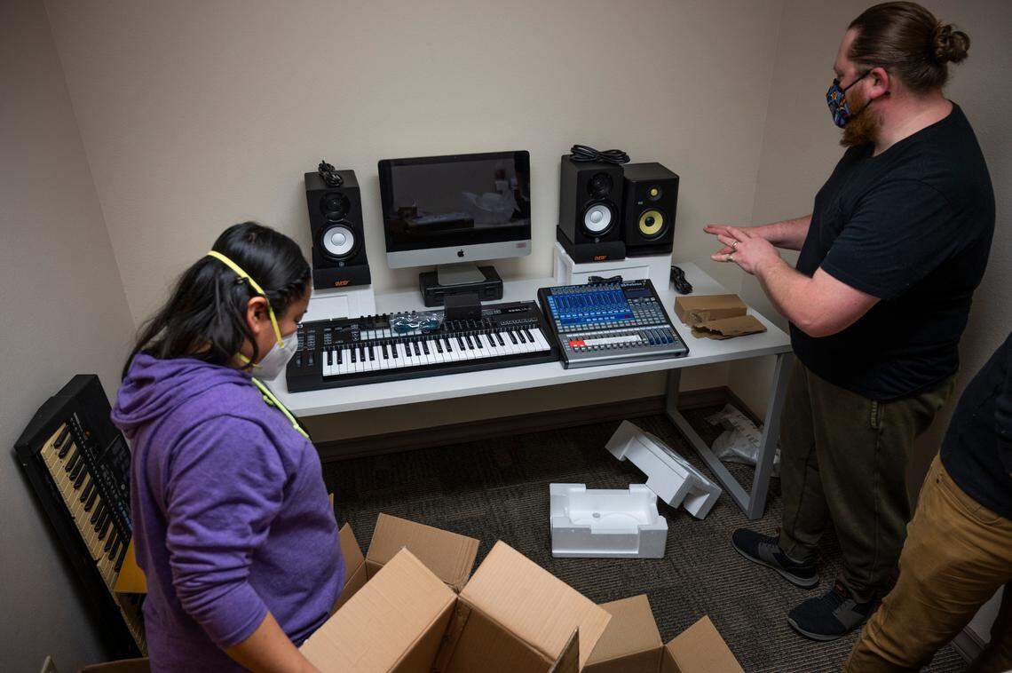 Gaby Salazar, left, and Justin Aceveda set up new podcast and music recording equipment on Tuesday, April 5, at the Northwest Indian College in Whatcom County.
