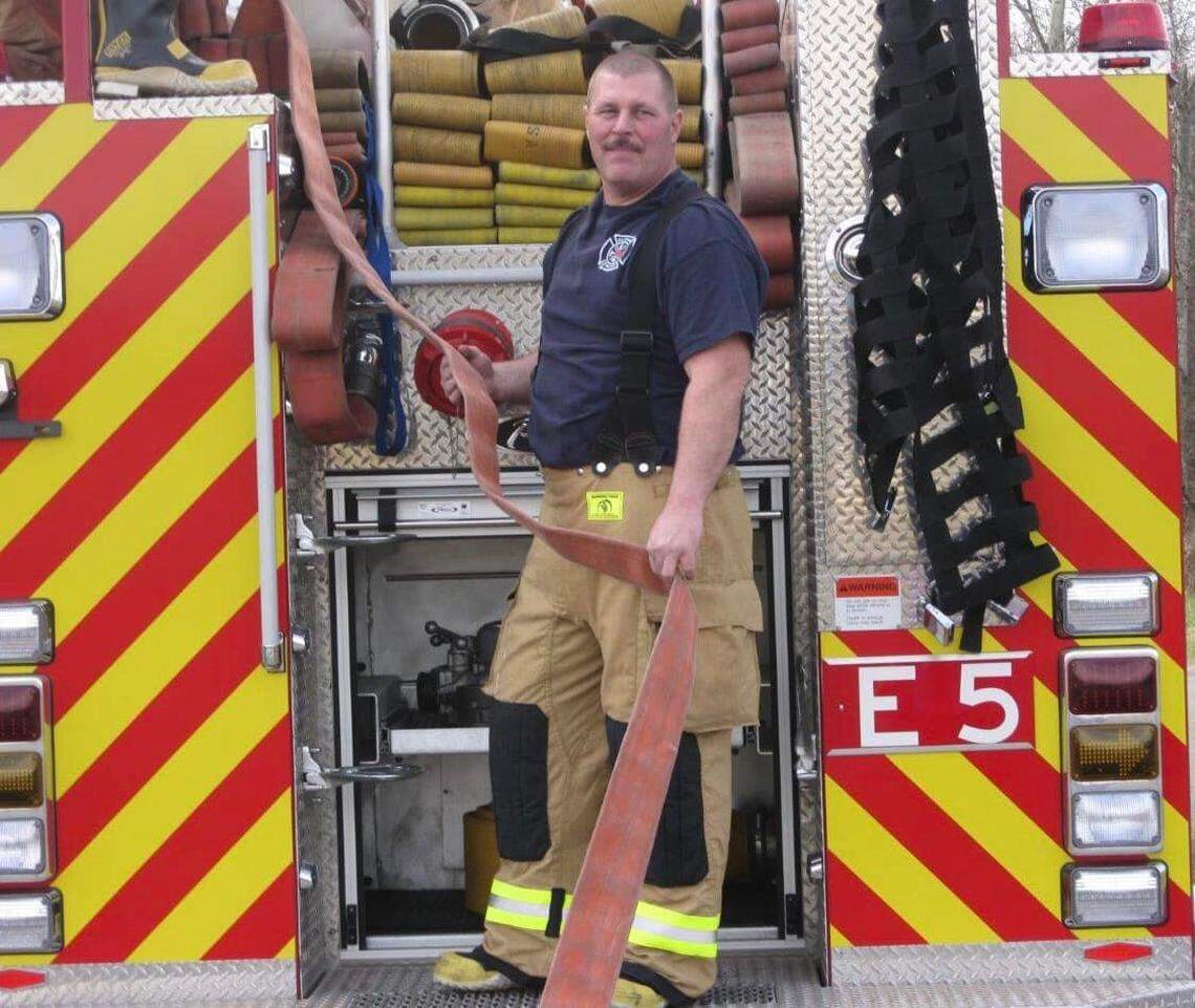 Gordon Neitling of the Bellingham Fire Department loads hose on the back of Engine 5. Neitling, who retired as a captain in June 2022, spent more than 30 years with the department.