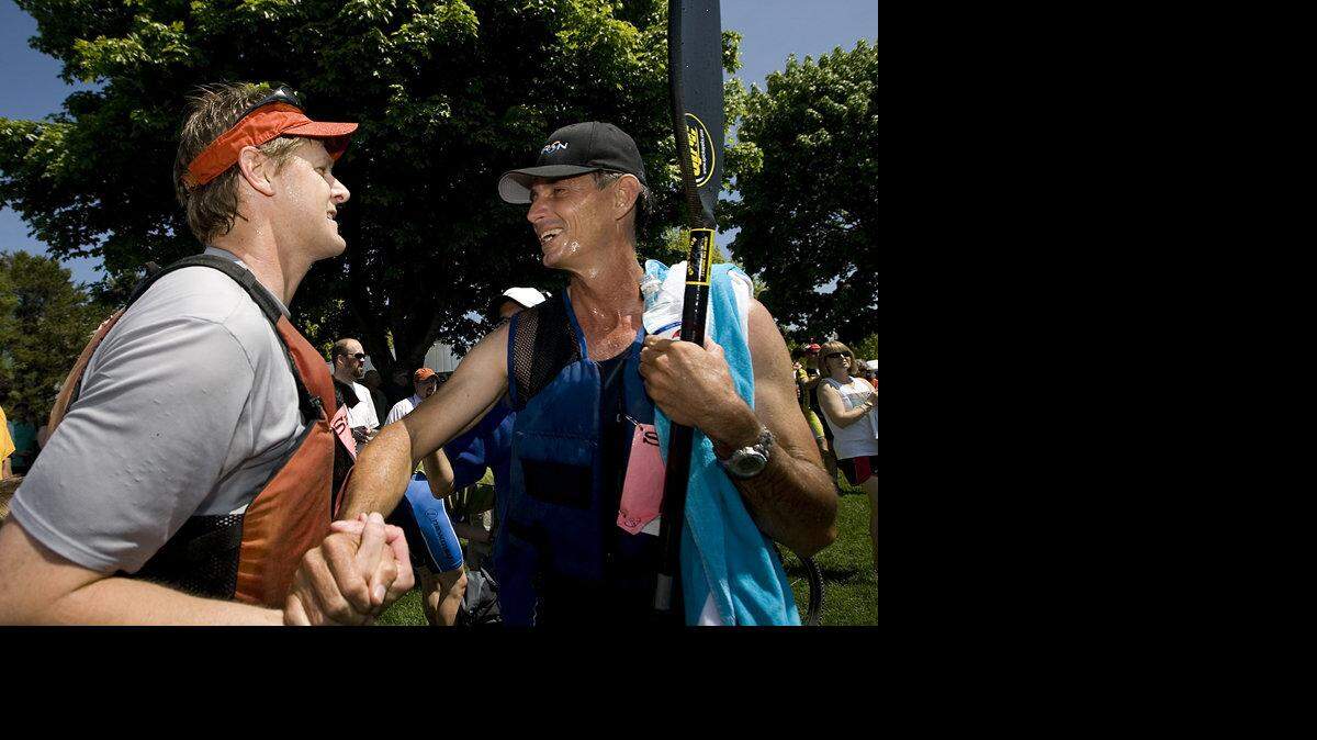 Kayakers Jeff Hilburn of team Bagelry, left, and Robert Clegg of team Barron Heating shake hands at the end of the 2009 Ski to Sea, on May 24, 2009.