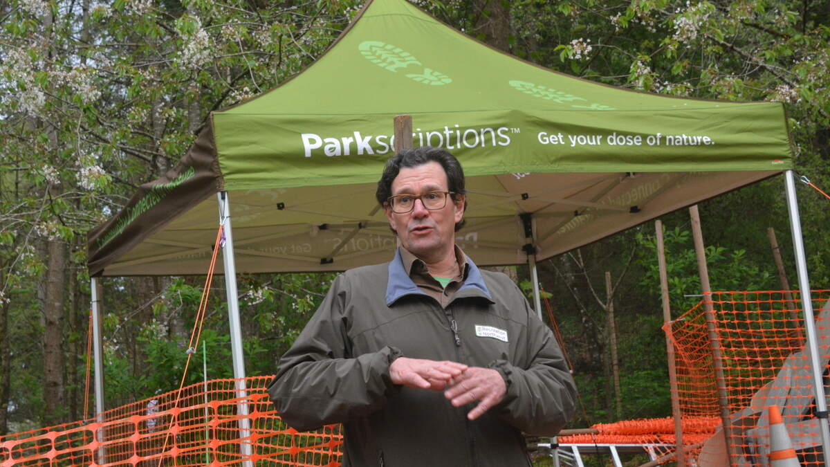 Todd Elsworth, executive director of Recreation Northwest, explains the features of the outdoor classroom being built in the Hundred Acre Wood on the south side of Bellingham in a ceremony on Thursday, May 4.