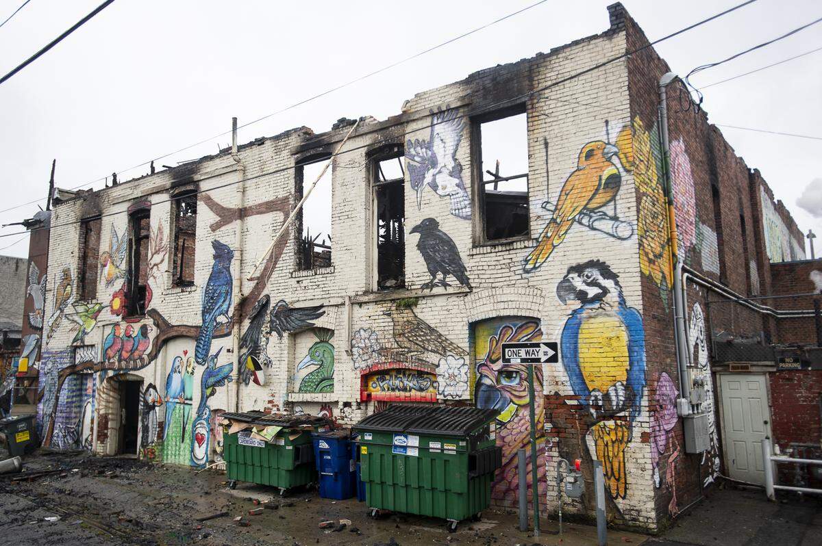 Some of the “Bird Alley” mural remains on the back of Hohl Feed & Seed after a two-alarm fire on Monday that destroyed the second floor and the granary tower in Bellingham. Shawn Cass, the artist behind the mural, started the process in 2016.