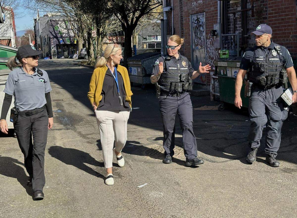 Bellingham, Wash., Mayor Kim Lund, second from left, joins Police Chief Rebecca Mertzig, third from left, and other Bellingham Police officers on an “emphasis patrol” of the downtown core on Monday,n March 18, 2024. It’s part of the mayor’s new focus on downtown issues such as crime, homelessness, drug use and other issues.