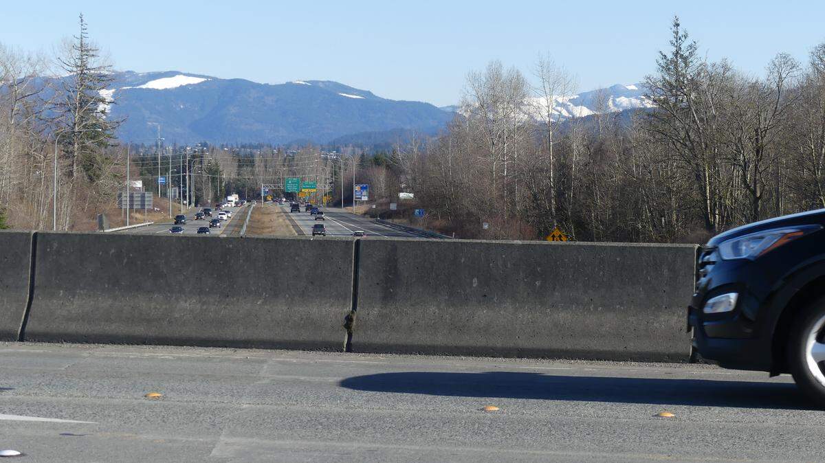 There is no sidewalk along the eastbound lane of Bakerview Road on the bridge over Interstate 5. Is it legal to walk along that lane as you cross the bridge heading toward Costco or Fred Meyer?