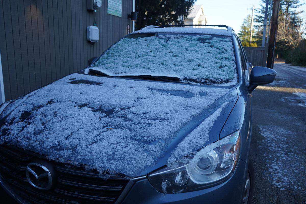 Icy snow forms on a car in an alley way off East Maple Street Monday, Nov. 28, in Bellingham.