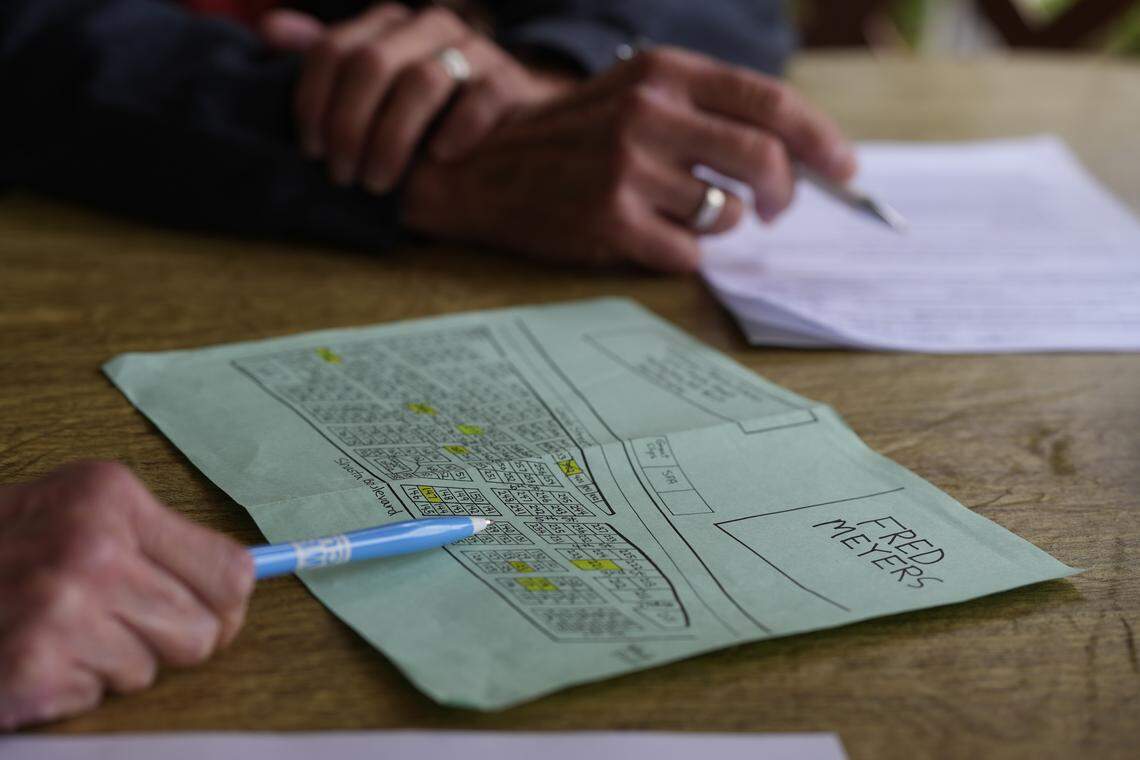 A resident of Lakeway Estates points to one of the homes on a map of the manufactured home park on Aug. 4 in Bellingham.