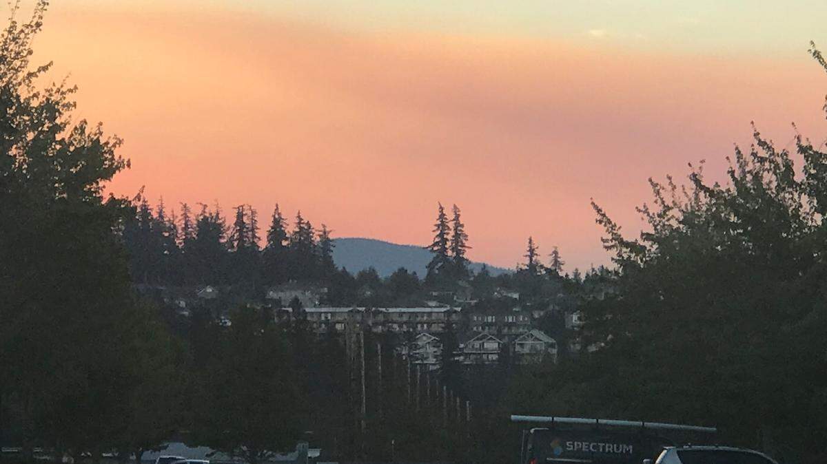 Smoke from wildfires near Mount Baker rises above the foothills in the Barkley area of Bellingham, Wash., on Friday, Sept. 9, 2022.