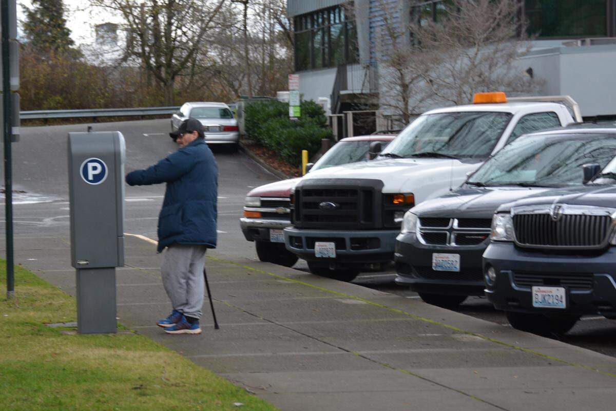 Shawn Michaels of Bellingham uses a parking pay station in front of Bellingham City Hall on Lottie Street.