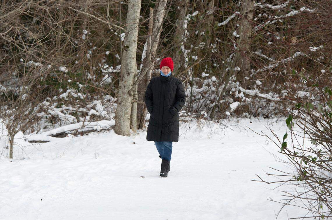 A woman walks a snow-covered Greenways trail on Wednesday, Dec. 29, in Bellingham.