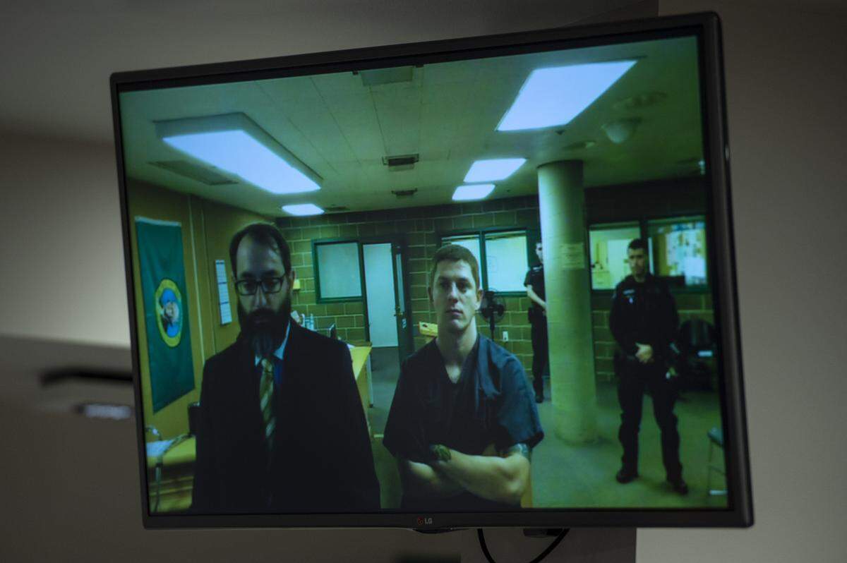 Cody Mitchell Brock, charged with one count of first-degree murder, stands with Richard Larson, his public defender, during his first-appearance at Whatcom County Superior Court Wednesday.