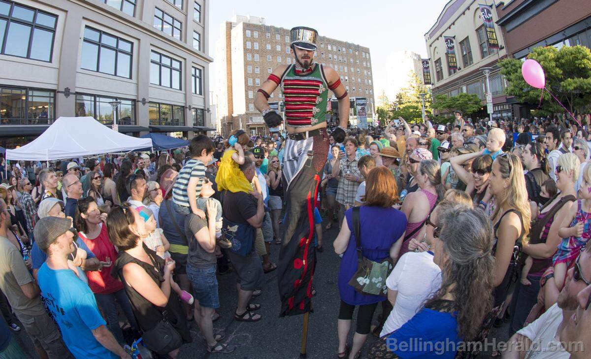 One of the performers dances through the crowd on stilts during Downtown Sounds in Bellingham.