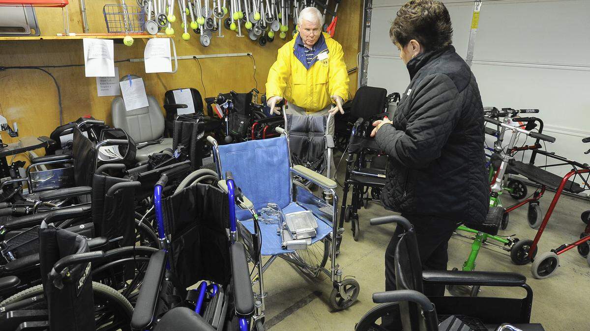 Lions member Darrell Dobson helps Rita Stephenson of Sedro Wooley look for a chair for her husband at the Bellingham Lions Club Wheelchair Warehouse in 2015.