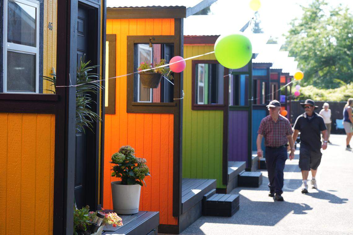 Community members toured the North Haven tiny home village Tuesday during its grand opening celebration in Bellingham. The village comprises 48 tiny homes, designed to help individuals transition from homelessness to permanent housing.