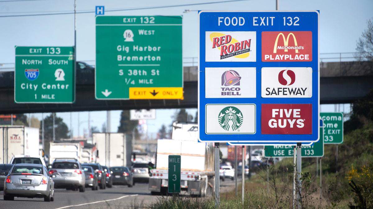 A sign on the side of Interstate 5 in Tacoma, Wash., lets drivers know there are various restaurants at the next exit on Friday, April 19, 2024.
