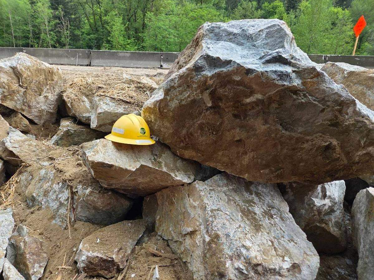 A Washington State Department of Transportation safety helmet sits atop the rubble of the iconic Bellingham rock along northbound Interstate 5 north of Lake Samish in southern Whatcom County, Wash. The rock was broken into pieces too small to display on Wednesday, May 6, 2026.