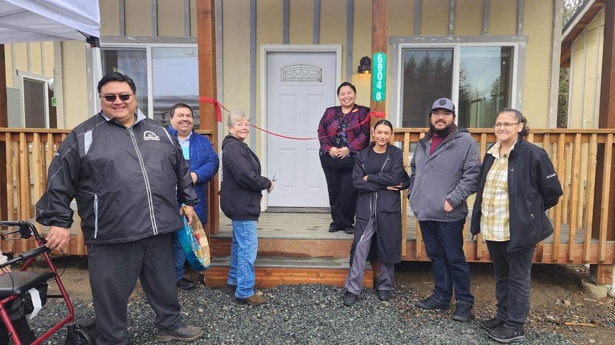 A group of Nooksack tribal and community members gather for a ribbon-cutting ceremony on February 20, 2024, to celebrate the completion of three new tiny homes in Deming, Wash.