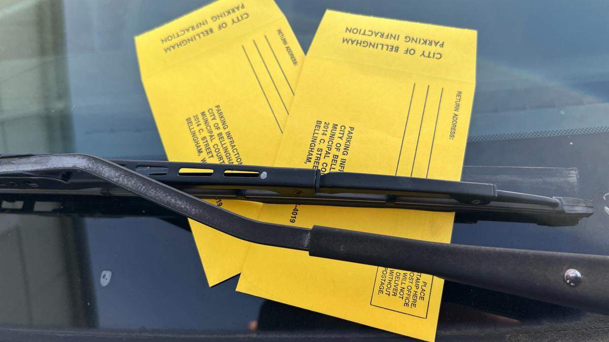 Traffic tickets sit on the windshield of a car parked on Commercial Street near Central Avenue in downtown Bellingham, Wash., on Jan. 29, 2026.
