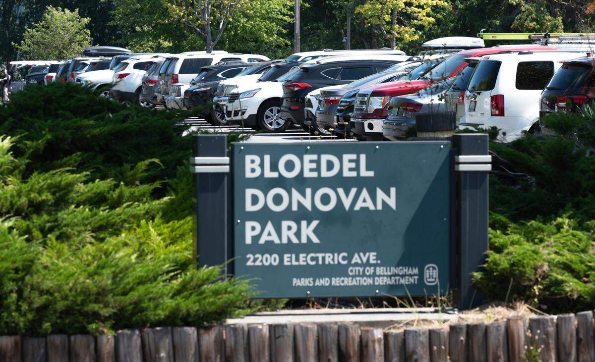 Cars fill the Bloedel-Donovan parking lot on a summer day at Lake Whatcom, Thursday, July 29, in Bellingham. Better signs, an overflow parking area and traffic flaggers should ease crowded conditions at the park, which has been busy since a swimming dock was installed.