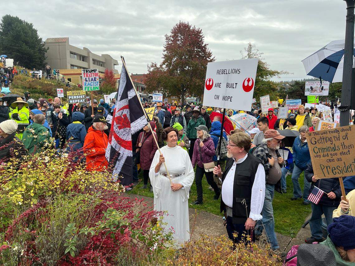 Protesters drssed at Princess Leia and Luke Skywalker of the “Star Wars” rebel allaiance, are among thousands of people who attended a No Kings rally against the Trump administration at Maritime Heritage Park in Bellingham, Wash., on Saturday, Oct. 18, 2025.
