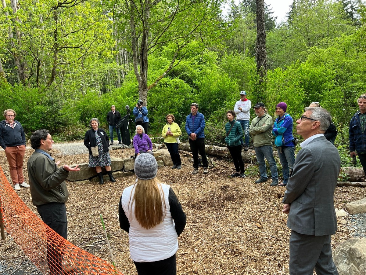 Todd Elsworth, second from left, executive director of Recreation Northwest, explains the features of an outdoor classroom under construction in the Hundred Acre Wood on Thursday, May 4. Mayor Seth Fleetwood is shown at far right.
