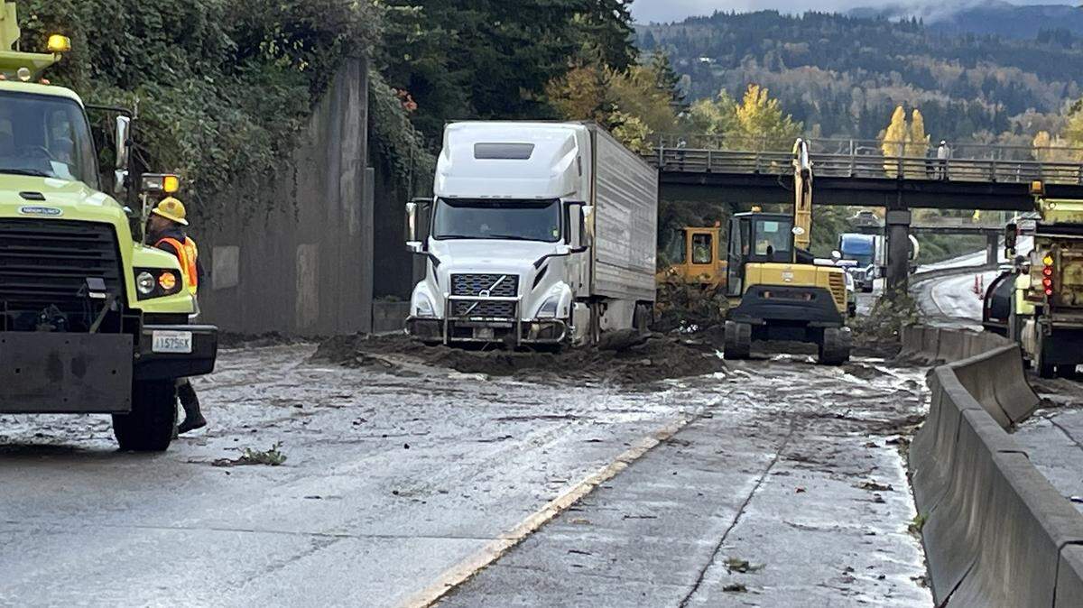 A semi trailer truck is stuck in a mudslide on Interstate 5 near a pedestrian crossing north of the Iowa Street overpass on Oct. 27. The driver was uninjured, the Bellingham Fire Department said.